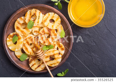 Grilled pineapple with honey Grilled pineapple with honey 35526525