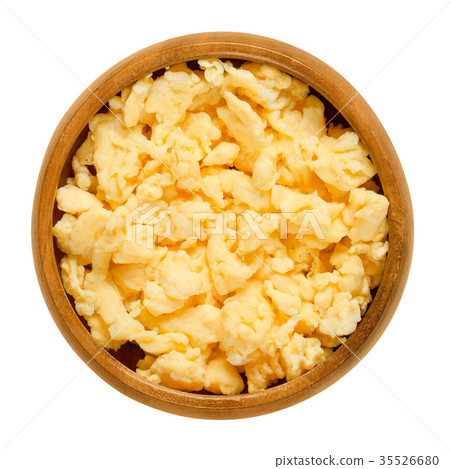 Scrambled eggs in wooden bowl over white 35526680