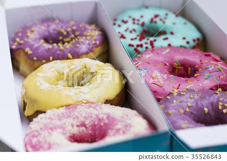 Fresh donuts with colorful glaze in turquoise box 35526843