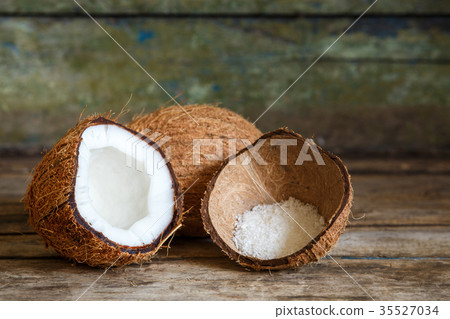 Fresh coconuts with flakes in shell on wood 35527034