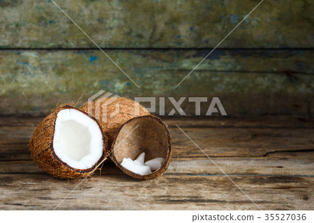 Fresh whole and half coconuts with coconut shreds Fresh whole and half coconuts with coconut shreds 35527036