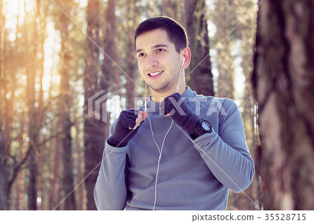 Sports man doing boxing exercise in forest. Winter 35528715