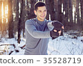 Sports man doing boxing exercise in forest. Winter 35528719