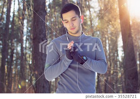 Sports man doing boxing exercise in forest. Winter 35528721