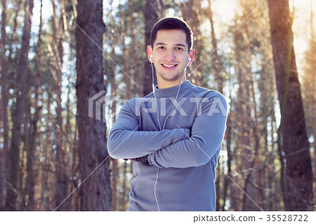 Sports man doing boxing exercise in forest. Winter Sports man doing boxing exercise in forest. Winter 35528722