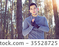 Sports man doing boxing exercise in forest. Winter 35528725