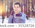Sports man doing boxing exercise in forest. Winter 35528726