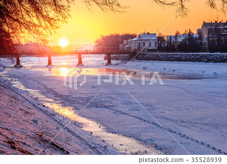 winter sunrise on the bank of ice covered river Uz 35528939