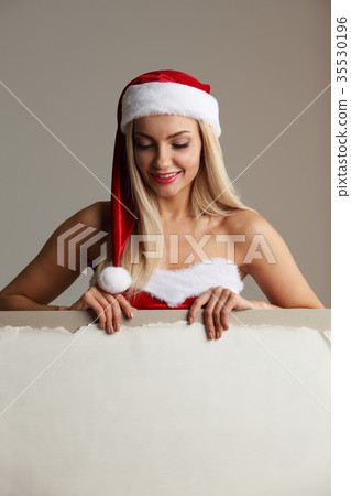 Santa girl holding blank billboard Santa girl holding blank billboard 35530196