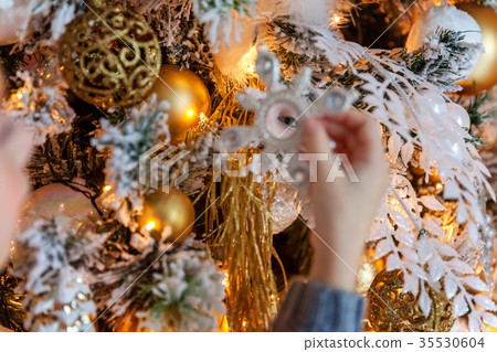 Young girl decorating Christmas tree 35530604