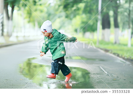 girl runs around the puddles in the autumn park, childhood game girl runs around the puddles in the autumn park, childhood game 35533328
