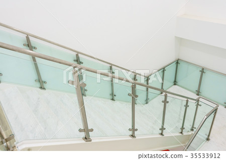 white marble stairs with steel and glass railing  35533912