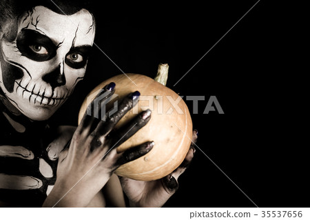 Attractive girl with skeleton makeup holds a 35537656