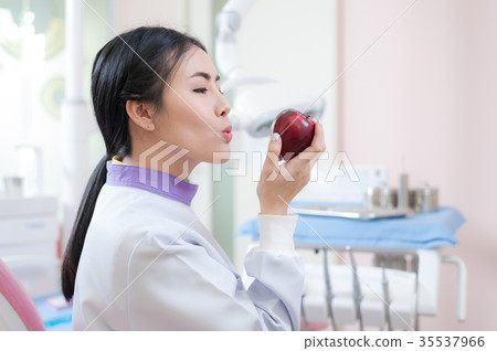Female dentist crossing armin dental clinic 35537966