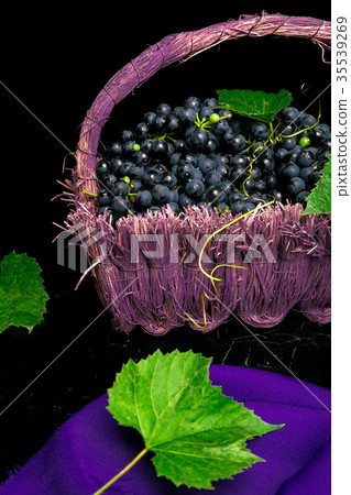 Red wine grapes in voiolet basket on bllack 35539269