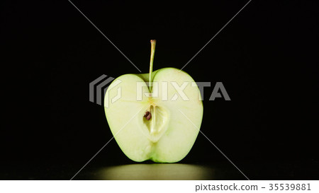 Half of green apple on a black background 35539881