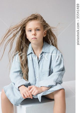 Stylish young teen girl over gray background Stylish young teen girl over gray background 35541489