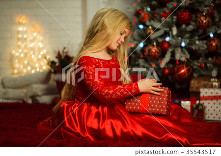 Beautiful blonde girl is wearing fashion red dress Beautiful blonde girl is wearing fashion red dress 35543517