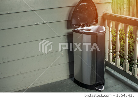 Trash on home porch. Smelly garbage bin Trash on home porch. Smelly garbage bin 35545433