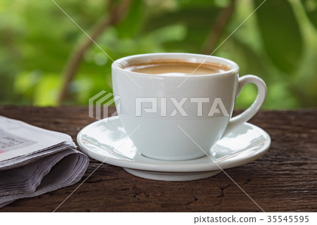 A cup of coffee and a newspaper A cup of coffee and a newspaper 35545595