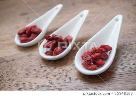 goji berries in chinese spoon on wooden table goji berries in chinese spoon on wooden table 35548193
