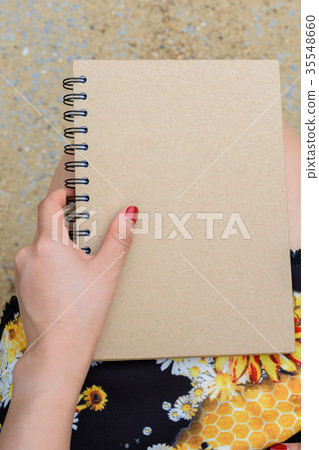Woman holding a book Woman holding a book 35548660