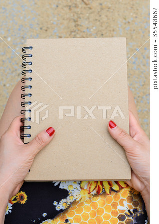 Woman holding a book Woman holding a book 35548662