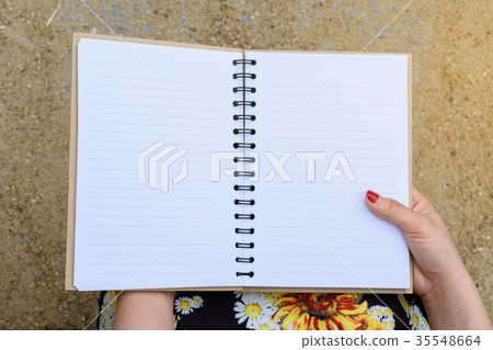 Woman holding a book Woman holding a book 35548664