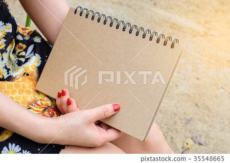 Woman holding a book Woman holding a book 35548665