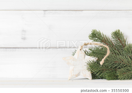 Wooden star ornament with christmas tree branch Wooden star ornament with christmas tree branch 35550300