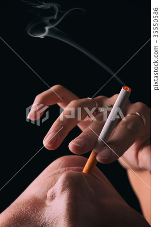 Smoking girl on a black background 35550586