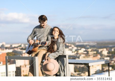 Man and woman with guitar outdoors Man and woman with guitar outdoors 35551492