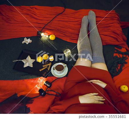 Young pregnant woman in red dress with tea cup Young pregnant woman in red dress with tea cup 35551681