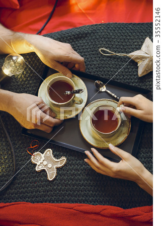 Two tea cups and for hands. Top view Two tea cups and for hands. Top view 35552146