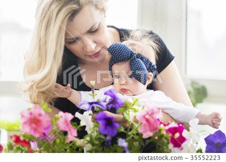 Mature woman embrace with baby girl Mature woman embrace with baby girl 35552223