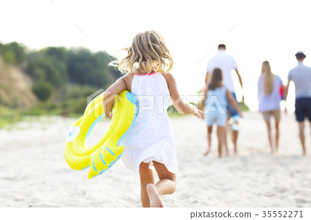 Young blonde girl running on the beech 35552271