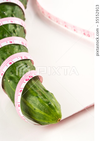Cucumber wrapped around a measure 35552913