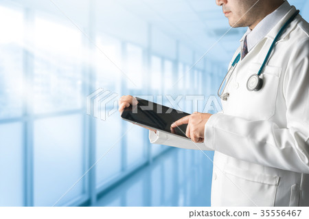Male doctor using tablet computer. 35556467