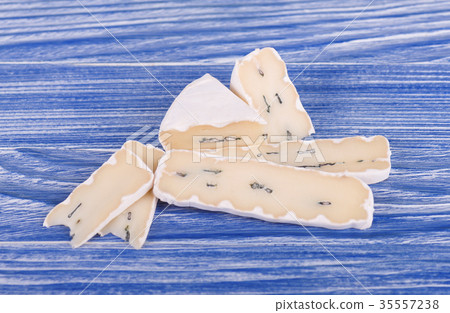 Blue cheese on blue wooden background 35557238