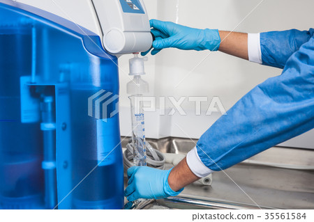 Filling a graduated cylinder with distilled water Filling a graduated cylinder with distilled water 35561584