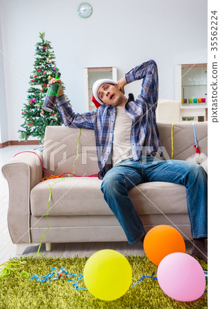 Man having hangover after christmas party Man having hangover after christmas party 35562224