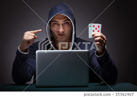 Young man wearing a hoodie sitting in front of a 35562407