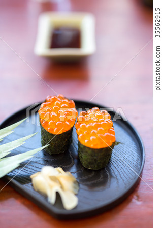 Sushi with caviar on a black plate with ginger 35562915