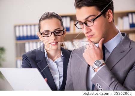 Businessman and businesswoman having discussion in Businessman and businesswoman having discussion in 35562963