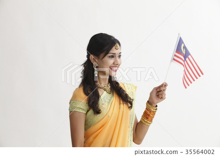 Indian woman in traditional clothing holding flag Indian woman in traditional clothing holding flag 35564002