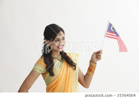 Indian woman in traditional clothing holding flag Indian woman in traditional clothing holding flag 35564004