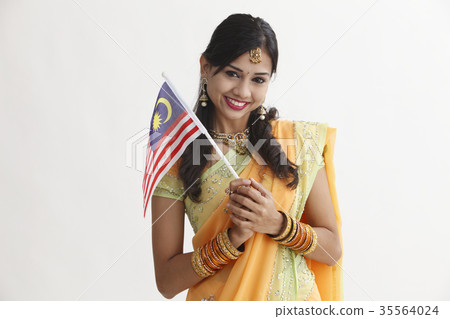 Indian woman in traditional clothing holding flag 35564024