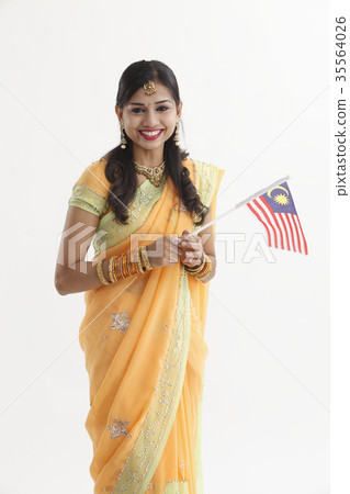 Indian woman in traditional clothing holding flag 35564026