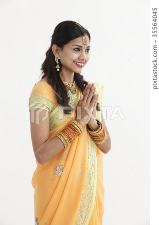 Indian woman in traditional clothing greeting Indian woman in traditional clothing greeting 35564045