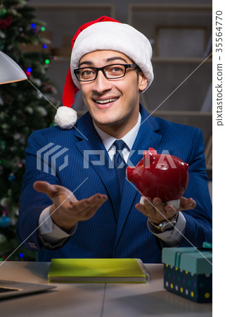 Businessman working late on christmas day in 35564770
